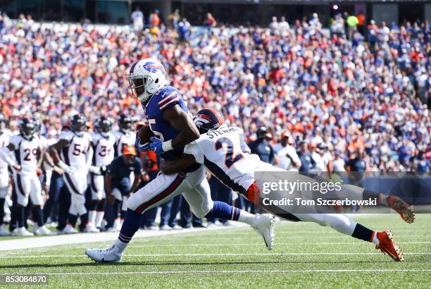 Charles Clay of the Buffalo Bills runs the ball as Darian Stewart of the Denver Broncos during an NFL game on September 24, 2017 at New Era Field in...