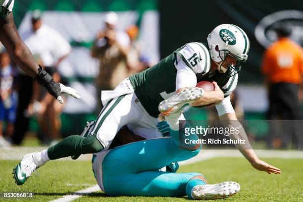 Josh McCown of the New York Jets is sacked by Cameron Wake of the Miami Dolphins during the first half of an NFL game at MetLife Stadium on September...