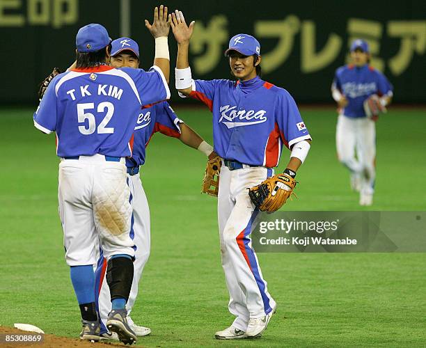 Infielders Kim Tae Kyun, Lee Bum Ho and Park Ki Hyuk of South Korea celebrate the win over Japan after the World Baseball Classic Pool A match...
