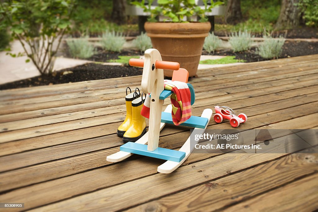 Toys, boots and rocking horse on deck