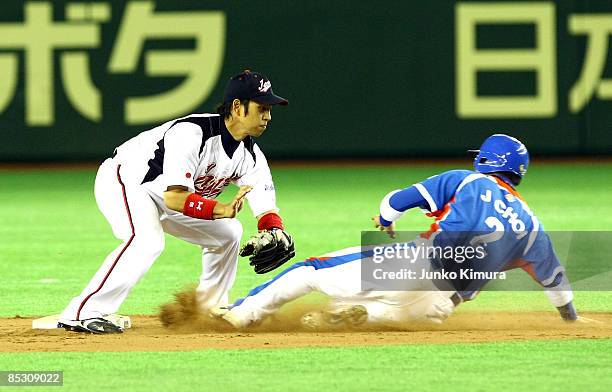 Infielder Hiroyuki Nakajima of Japan tags out Infielder Choi Jeong of South Korea in the top half of the ninth inning during the World Baseball...
