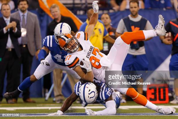 Seth DeValve of the Cleveland Browns is tackled by Malik Hooker and Matthias Farley of the Indianapolis Colts during the first half at Lucas Oil...