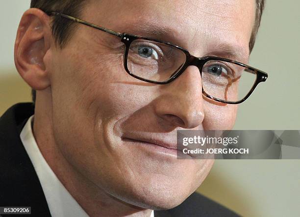 Helg Scarbi, dubbed the "Swiss Gigolo", smiles as he waits for his judgement at court during his trial on March 9, 2009 in Munich, southern Germany,...