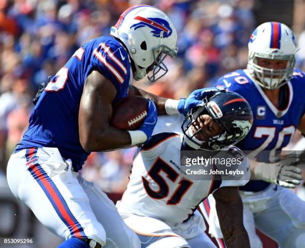 Buffalo Bills tight end Charles Clay tries to shove Denver Broncos inside linebacker Todd Davis out of the way after a catch during the second...