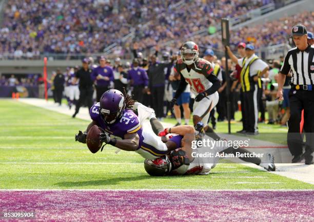 Dalvin Cook of the Minnesota Vikings is tackled with the ball in the first half of the game against the Tampa Bay Buccaneers on September 24, 2017 at...