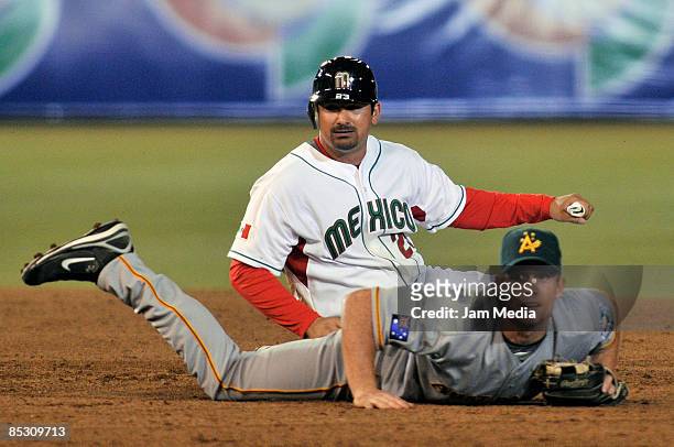 Australian baseball player Daniel Berg and Adrian Gonzalez of Mexico in second base during their World Baseball Classic 2009 match at the Foro Sol...