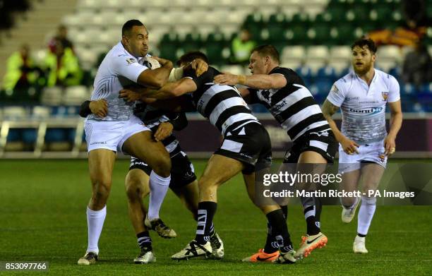 Huddersfield Giants Antonia Kaufusi is tackled by Widnes Vikings Widnes Vikings Willie Isa, Paul Clough and Danny Tickle, during the First Utility...