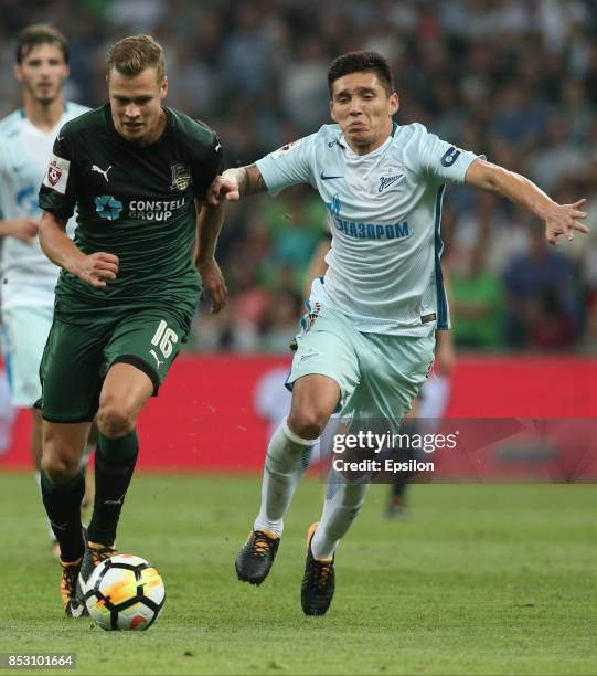 Viktor Claesson of FC Krasnodar is challenged by Matias Kranevitter of FC Zenit St. Petersburg during the Russian Premier League match between FC...