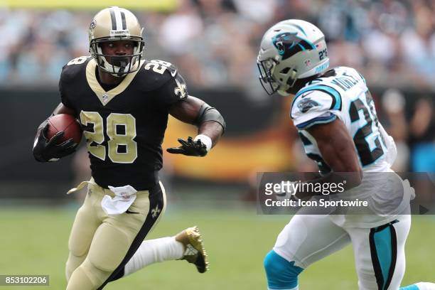 New Orleans Saints running back Adrian Peterson runs as Carolina Panthers free safety Kurt Coleman gives chase during the first quarter of the game...