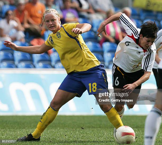 Nilla Fischer from Sweden competes against Linda Bresonik from Germany during the Women Algarve Cup match between Germany and Sweden at the Estadio...