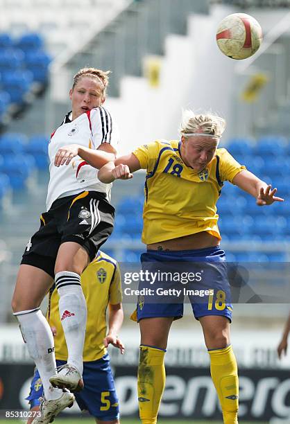 Kim Kulig from Germany and Nilla Fischer from Sweden jump for a header during the Women Algarve Cup match between Germany and Sweden at the Estadio...