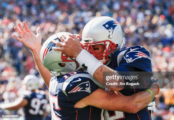 Tom Brady reacts with Chris Hogan of the New England Patriots after a touchdown during the second quarter of a game against the Houston Texans at...