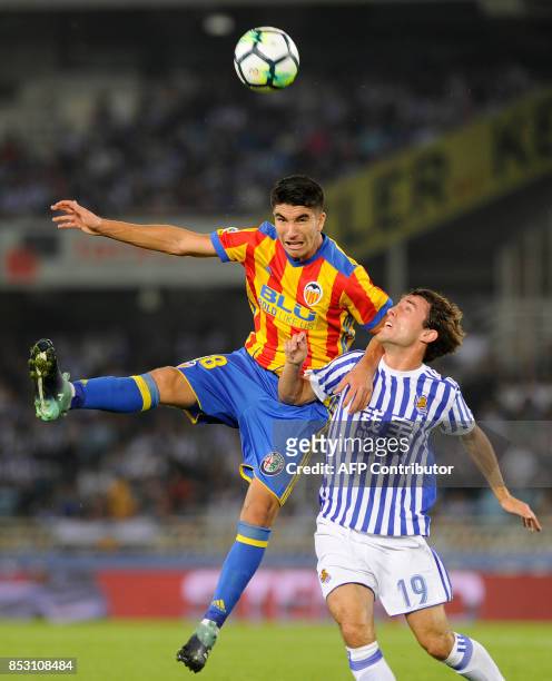 Valencia's midfielder from Spain Carlos Soler vies with Real Sociedad's defender from Spain Alvaro Odriozola during the Spanish league football match...
