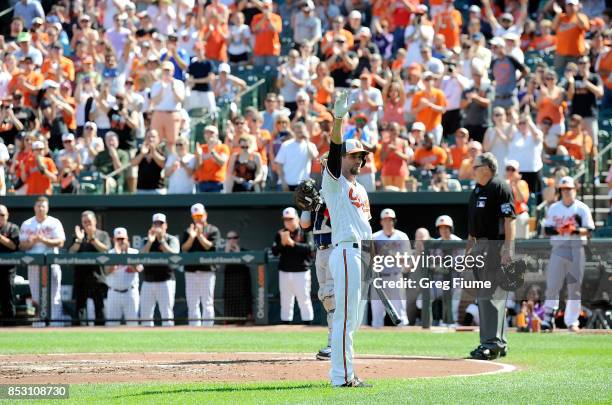 Hardy of the Baltimore Orioles waves to the crowd after getting a standing ovation before his first at bat in the first inning against the Tampa Bay...