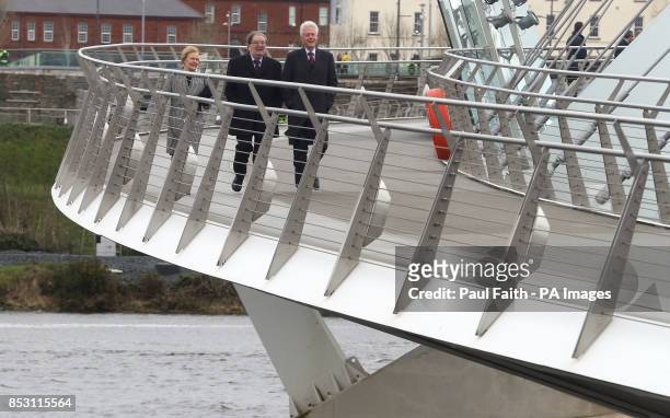 Former US President Bill Clinton with former SDLP leader John Hume and his wife Pat as they walk along Peace Bridge in Londonderry in Derry city...