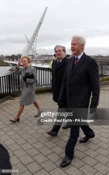 Former US President Bill Clinton with former SDLP leader John Hume and his wife Pat as they walk along Peace Bridge in Londonderry in Derry city...