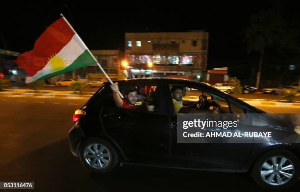 KIraqi Kurds fly Kurdish flags during an event to urge people to vote in the upcoming independence referendum in Arbil, the capital of the autonomous...