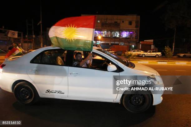 KIraqi Kurds fly Kurdish flags during an event to urge people to vote in the upcoming independence referendum in Arbil, the capital of the autonomous...
