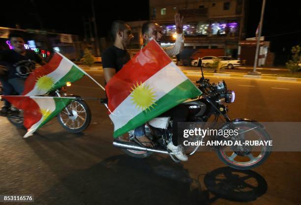 KIraqi Kurds fly Kurdish flags during an event to urge people to vote in the upcoming independence referendum in Arbil, the capital of the autonomous...