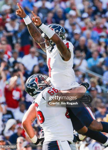 DeShaun Watson celebrates with Nick Martin of the Houston Texans after a touchdown during the third quarter of a game against the New England...