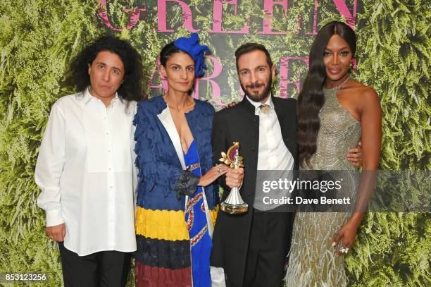 Tiziano Guardini , winner of the The Franca Sozzani GCC Award for Best Emerging Designer, poses backstage with presenters Sara Sozzani Maino, Helen...