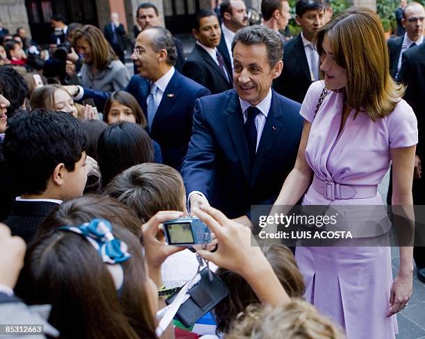 French First Lady Carla Bruni , French President Nicolas Sarkozy , Mexican President Felipe Calderon and his wife Margarita Zavala shake hands with...