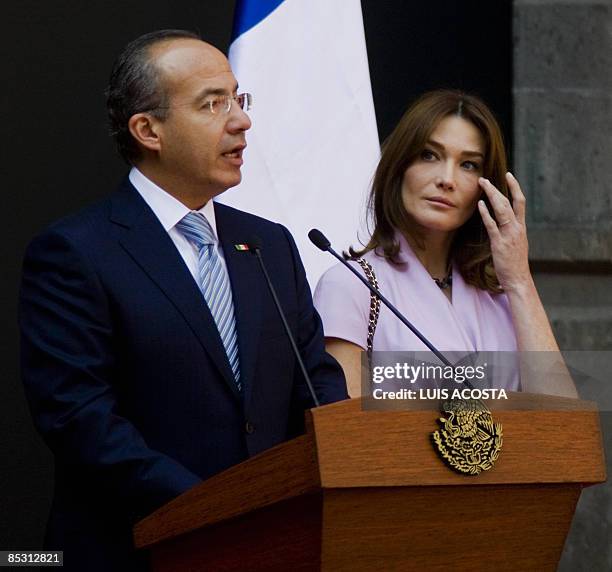 French First Lady Carla Bruni , listens to Mexican President Felipe Calderon during a welcoming ceremony at the National Palace in Mexico City on...