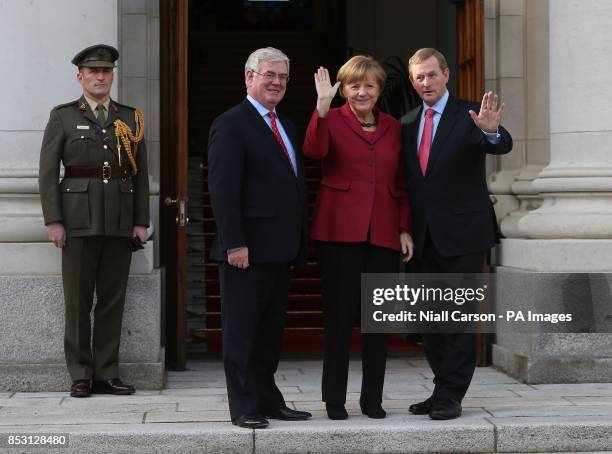 Tanaiste Eamon Gilmore, German Chancellor Angela Merkel and Taoiseach Enda Kenny arrive for a press conference at Government Buildings in Dublin...