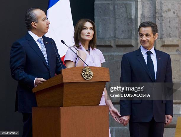 French President Nicolas Sarkozy and his wife Carla Bruni , listen to Mexican President Felipe Calderon during a welcoming ceremony at the National...