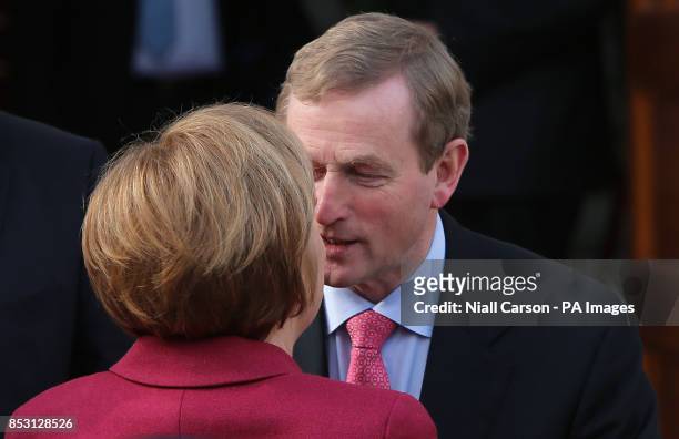 German Chancellor Angela Merkel is greeted by Taoiseach Enda Kenny as she arrives for a press conference at Government Buildings in Dublin today.