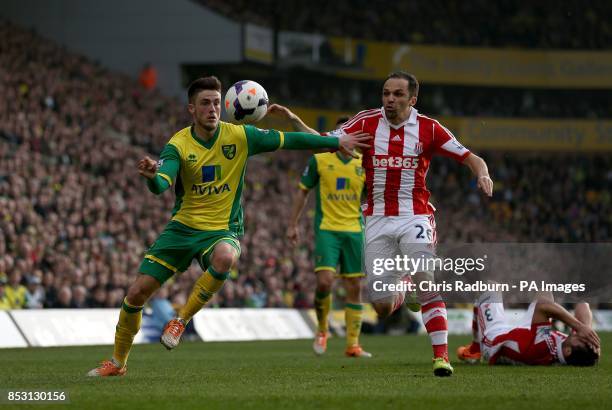 Stoke City's Matthew Etherington and Norwich City's Ricky van Wolfswinkel battle for the ball