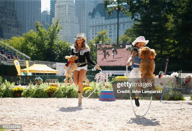 Dogs are seen performing tricks during the 4th Annual Rolex Central Park horse show at Wollman Rink, Central Park on September 24, 2017 in New York...