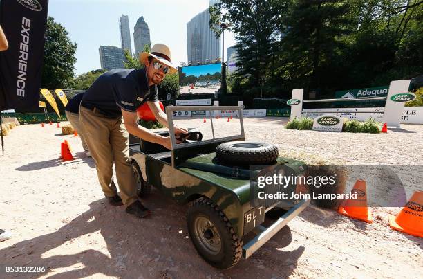 An attendant displays a miniature car at the 4th Annual Rolex Central Park horse show at Wollman Rink, Central Park on September 24, 2017 in New York...