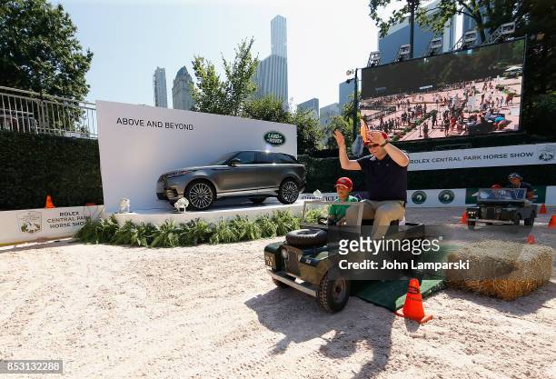 Child enjoys a miniature car ride at the 4th Annual Rolex Central Park horse show at Wollman Rink, Central Park on September 24, 2017 in New York...