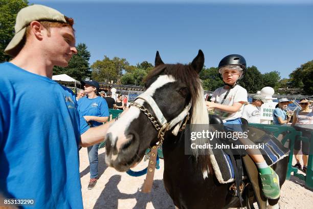 Child enjoys a pony ride during the 4th Annual Rolex Central Park horse show at Wollman Rink, Central Park on September 24, 2017 in New York City.