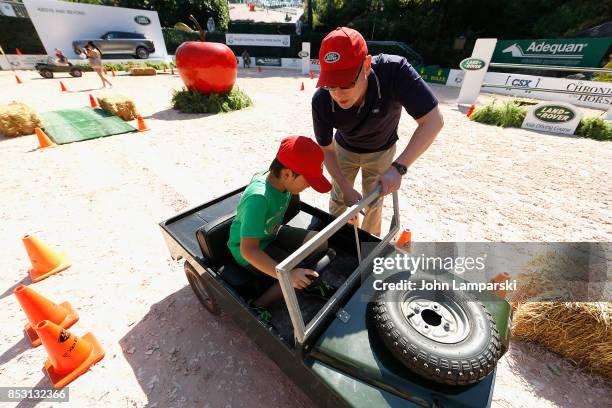 Child enjoys a miniature car ride at the 4th Annual Rolex Central Park horse show at Wollman Rink, Central Park on September 24, 2017 in New York...