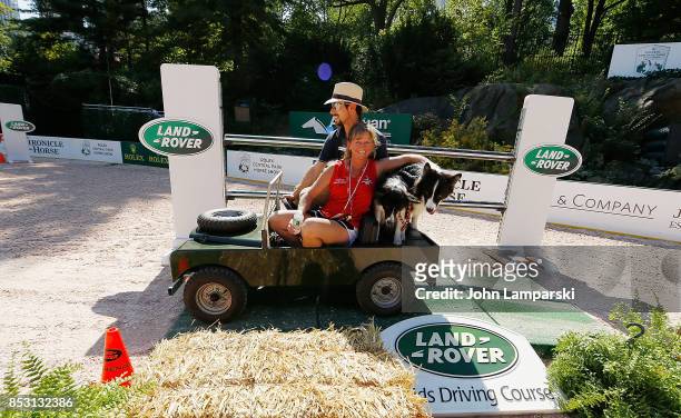 Dogs are seen riding a miniature car at the 4th Annual Rolex Central Park horse show at Wollman Rink, Central Park on September 24, 2017 in New York...