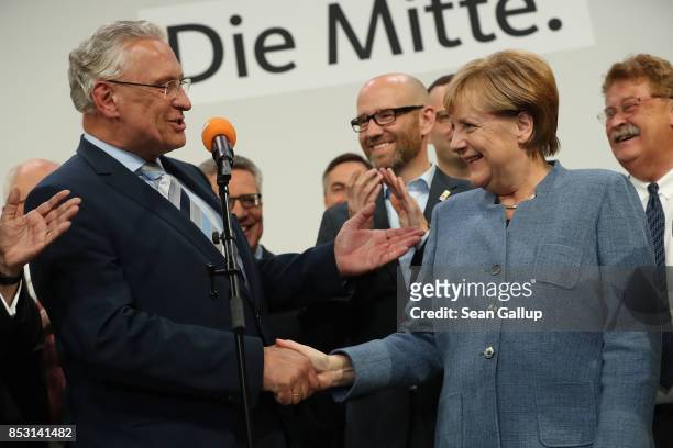 German Chancellor and Christian Democrat Angela Merkel shakes hands with leading member of the Bavarian Chrisitan Democrats Joachim Herrmann at CDU...