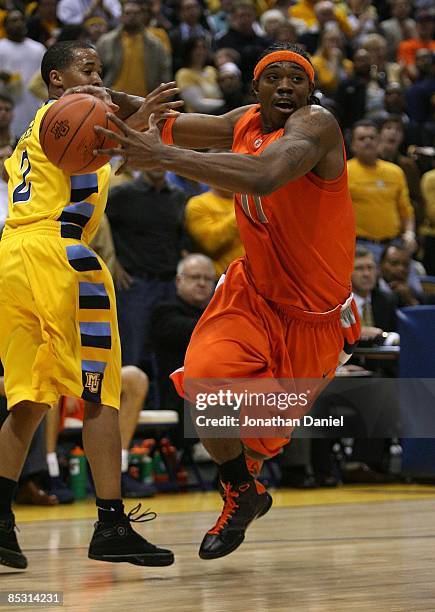 Paul Harris of the Syracuse Orange tries to drive around Maurice Acker of the Marquette Golden Eagles on March 7, 2009 at the Bradley Center in...