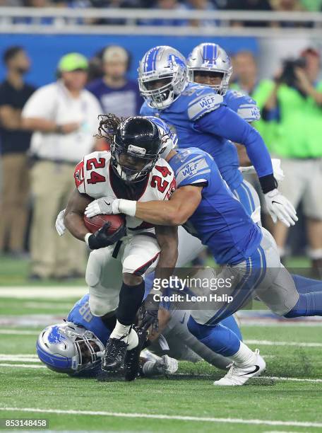 Devonta Freeman of the Atlanta Falcons runs for a short gain as Miles Killebrew of the Detroit Lions makes the stop during the first quarter of the...