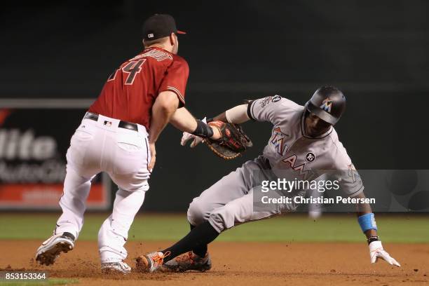 Dee Gordon of the Miami Marlins is tagged out in a run down by infielder Paul Goldschmidt of the Arizona Diamondbacks during the MLB game at Chase...