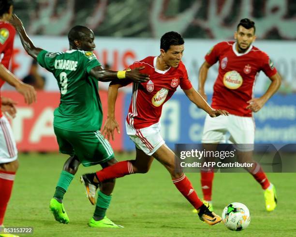 Etoile du Sahel's striker Amine Chemiti vies with Ahly Tripoli's forward Vivien Mabide during the African Champions league quarter-final football...