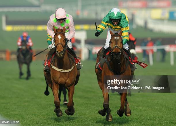 More Of That ridden by Barry Geraghty crosses the line ahead of Annie Power ridden by Ruby Walsh to win the Ladbrokes World Hurdle during St...