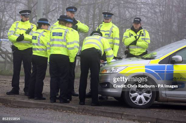 Police at a cordon on the A146 after four people have died when a helicopter came down in thick fog in a field in Gillingham, near Beccles, Norfolk,...