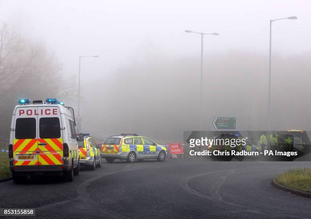 Police at a cordon on the A146 after four people have died when a helicopter came down in thick fog in a field in Gillingham, near Beccles, Norfolk,...