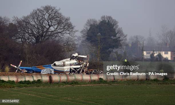 The wreckage of a helicopter alongside the A146 after four people have died when a helicopter came down in thick fog in a field in Gillingham, near...