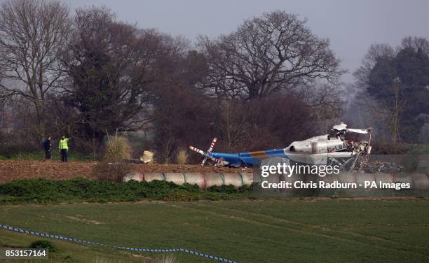 The wreckage of a helicopter alongside the A146 after four people have died when a helicopter came down in thick fog in a field in Gillingham, near...