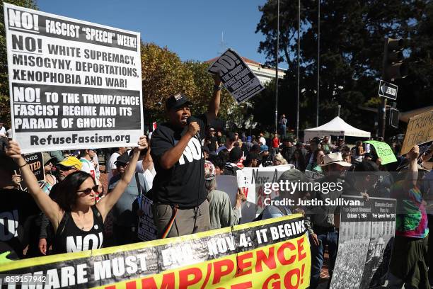 Protesters hold signs during a free speech rally with right wing commentator Milo Yiannopoulos at U.C. Berkeley on September 24, 2017 in Berkeley,...