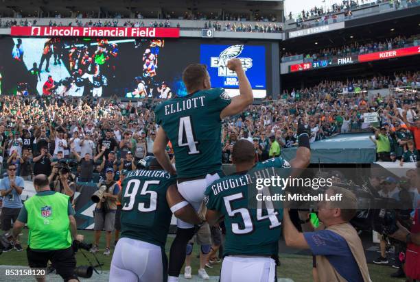 Kamu Grugier-Hill and Mychal Kendricks of the Philadelphia Eagles carry Jake Elliott of the Philadelphia Eagles off the field after the game against...