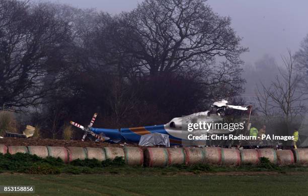 The wreckage of a helicopter alongside the A146 after four people have died when a helicopter came down in thick fog in a field in Gillingham, near...